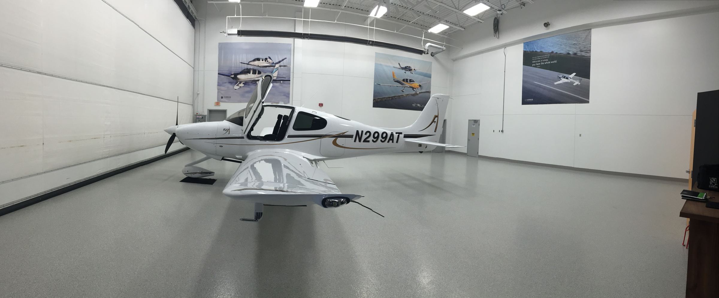 Cirrus SR20 N299AT in a hangar with its doors open